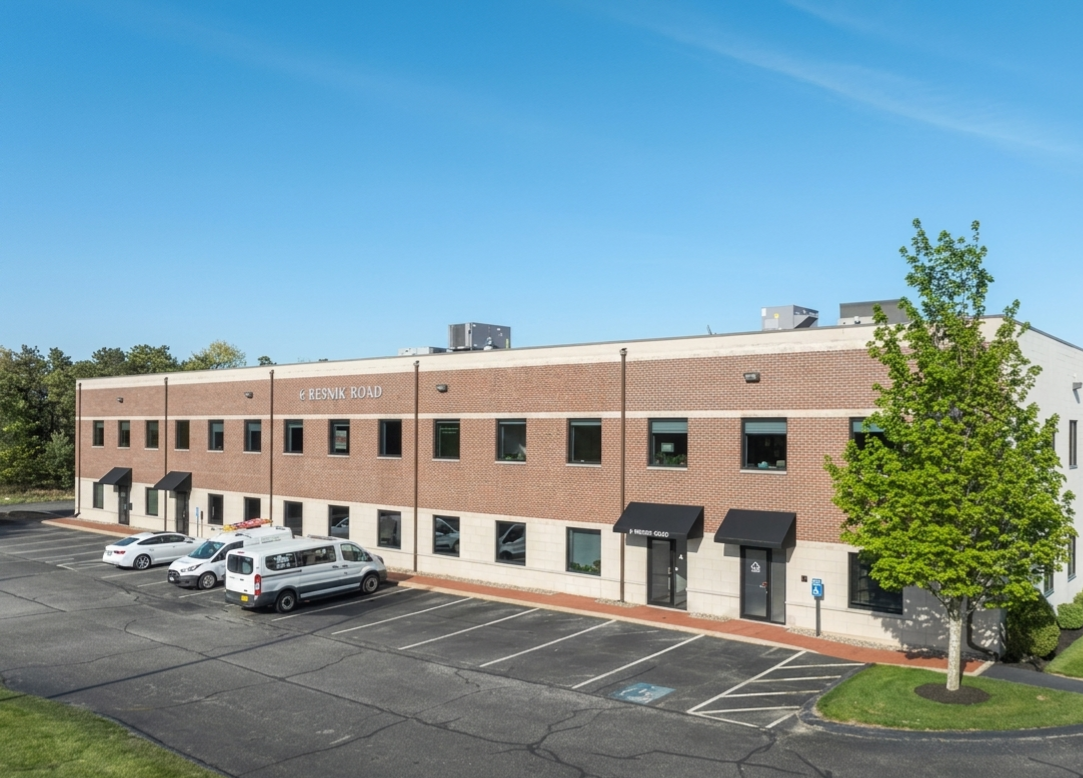 Brick Building with vans in front of it. 